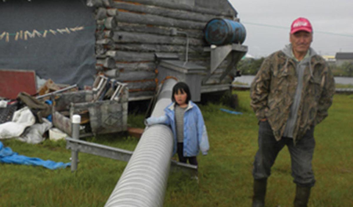 Man and girl surveying water line