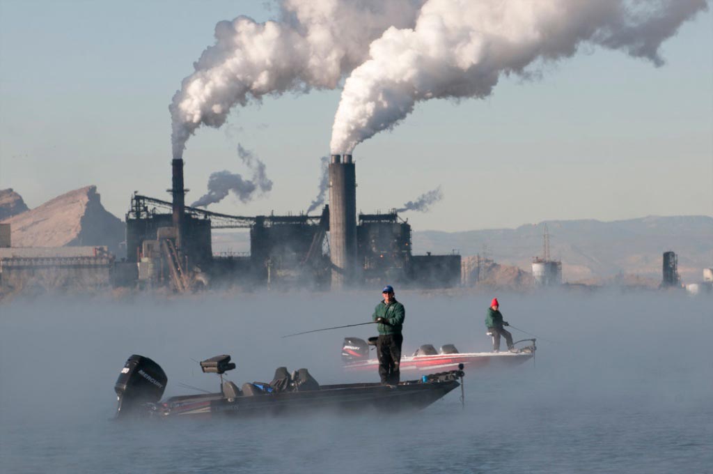 fishermen in front of powerplant